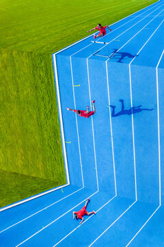 Young man jumping over hurdle into abyss