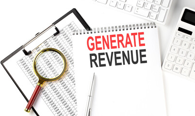 Office desk table with keyboard, notepad ,chart and calculator. Top view with text GENERATE REVENUE