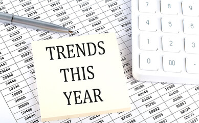 TRENDS THIS YEAR - business concept, message on sticker on chart background