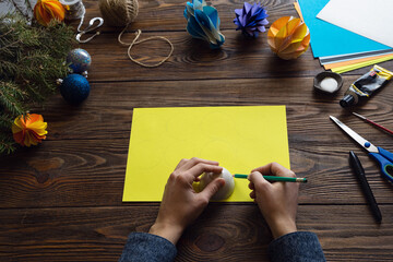 Making paper ornaments in the form of honeycombs for a Christmas tree. Origami. Manufacturing...