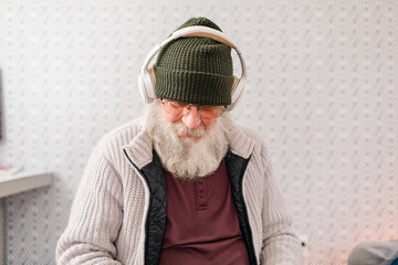 Trendy greybeard with headphones portrait