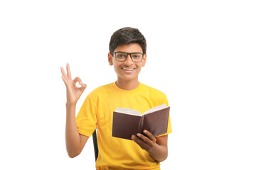 Indian boy with diary on white background.