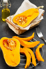 Cut pumpkin on metal stand on paper.