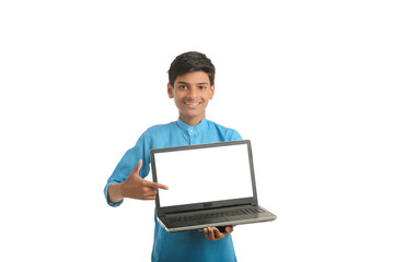 Indian child wearing traditional cloth and showing laptop screen