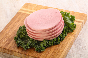 Slices pork sausage over board