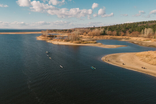 Autumnal landscape and a rowing team training on river