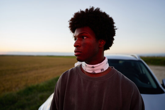 Man mear car in field