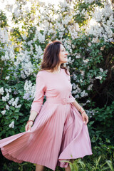 beautiful brunette woman in a dress with lilac flowers