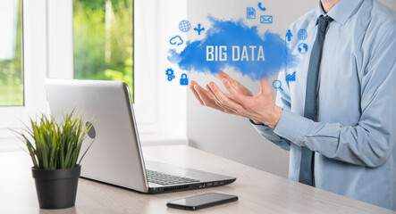 Businessman holds the inscription , word BIG DATA. Padlock , brain ,man, planet,graph, magnifier, gears, cloud, grid, document, letter, phone icon.
