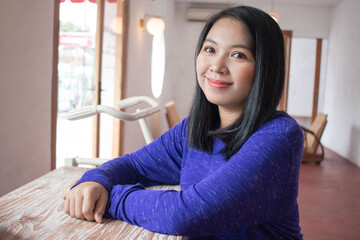 a beautiful woman smiling and sitting