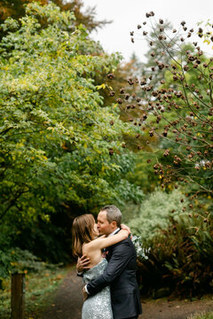 Couple Kissing in Woods on Wedding Day