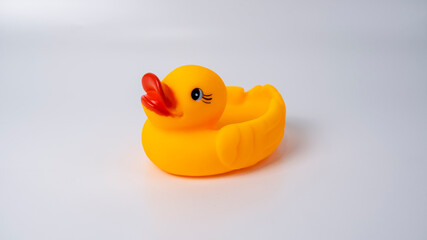 The toys of mother duck and duckling form several formations on white background.