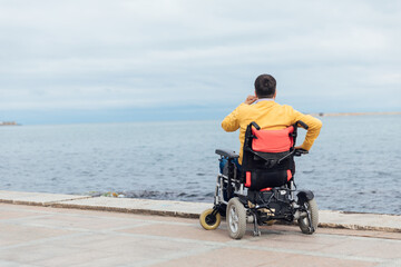 a man with disabilities in a wheelchair walks around the city