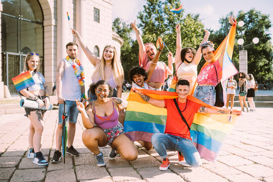 Cheerful female and male protesters during pride event in park