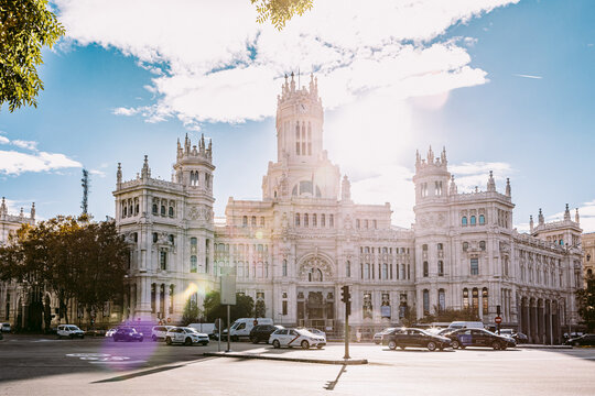Madrid, Spain - November 26, 2021: Madrid City Hall in the Plaza de Cibeles with the sun in the background leaving flares in the image