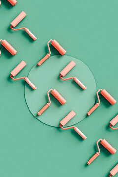 Paint roller brushes in rows on a green background