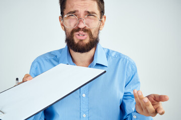 bearded man in blue shirt documents manager professional