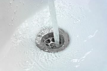 Water drains whirly in the wash sink in the bathroom