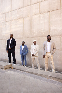 Stylish men standing on street stairs