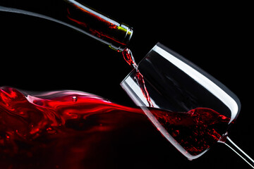 Red wine being poured into glass.