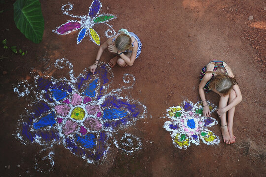 2 girls create mandalas in their back yard in India