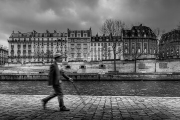 Paris, France - November 28, 2021: A man with a hat, dressed as at the beginning of the century , walks in the streets of Paris