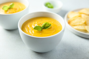 Traditional homemade pumpkin soup with fresh basil