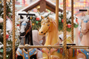 Moscow, Russia, December 7, 2021: Christmas market with New Year Tree and retro carousel horse on Red Square, between GUM and Kremlin decorated and illuminated. Red Square. 