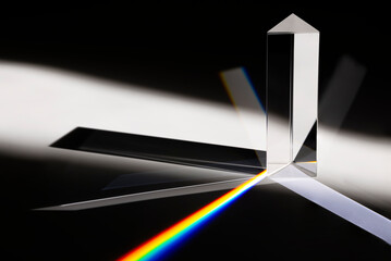 Triangular Prism dispersing sun beam splitting into a spectrum on white background