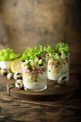 Green salad with ham and cheese served in a glass