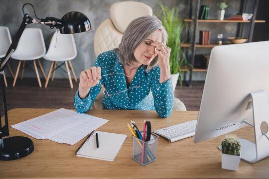 Photo of aged woman unhappy sad upset tired problem failure mistake sit desk break pause work distance indoors