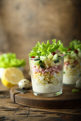 Green salad with ham and cheese served in a glass