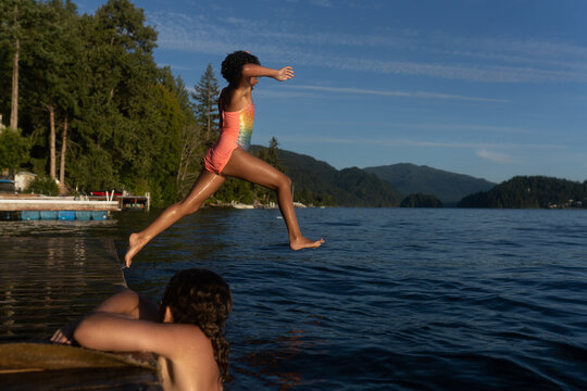 Girl leaps from dock at lake