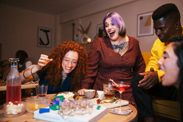 Diverse friends laughing while playing game