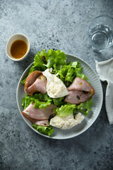 Green salad with mortadella and burrata cheese