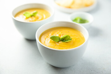 Traditional homemade pumpkin soup with fresh basil
