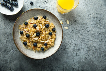 Obraz na płótnie Canvas Homemade oatmeal porridge with blueberry and almond flakes