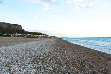Fototapeta na wymiar beautiful sea shore with blue water with pebbles