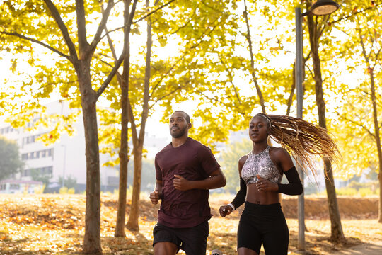 Black athletes running in autumn morning