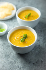 Traditional homemade pumpkin soup with fresh basil