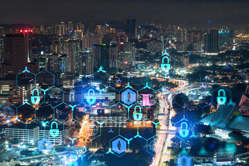 Glowing padlock hologram, night panoramic city view of Kuala Lumpur, Malaysia, Asia. The concept of...