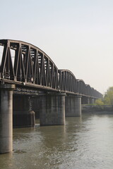 Fototapeta na wymiar Iron bridge on the Po river in Italy