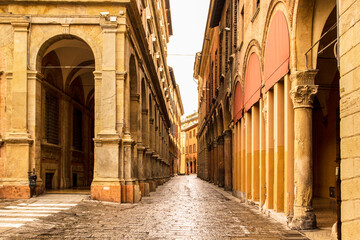 Beautiful Italian street, colourful buildings with porticos. Bologna, Italy.
