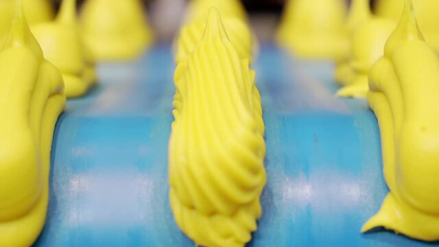 Moving confectionery on a conveyor line close-up.