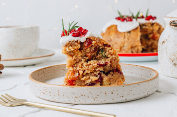 Traditional Christmas fruit pudding on white festive background.