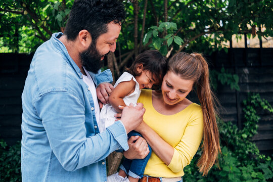 Cheerful family spending leisure time in back yard