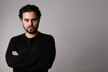 Bearded young man, confident attitude, posing over white background. Isolated.