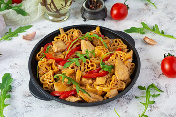 Tasty pasta in tomato sauce with chicken, pepper and herbs on white background