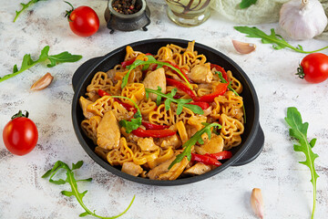 Tasty pasta in tomato sauce with chicken, pepper and herbs on white background