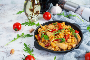 Tasty pasta in tomato sauce with chicken, pepper and herbs on white background